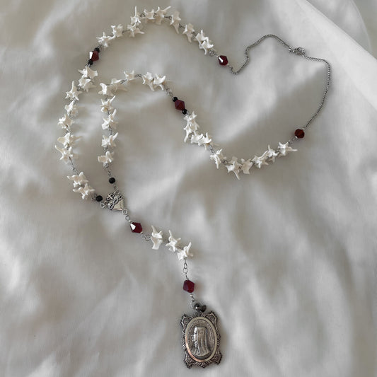 Bleeding heart bone rosary w/ Catholic Relic