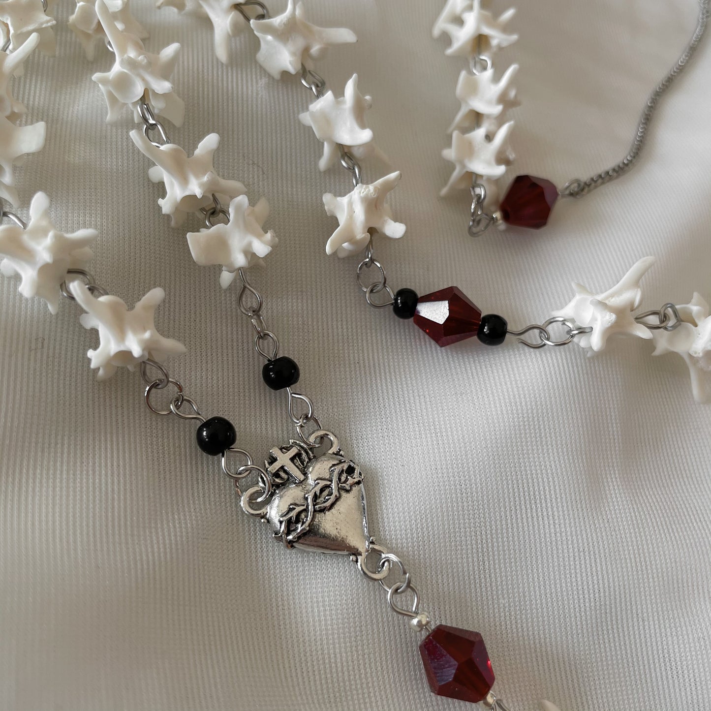 Bleeding heart bone rosary w/ Catholic Relic