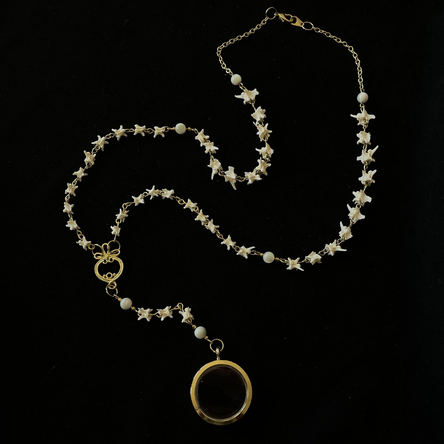 Bone rosary w/ glass locket